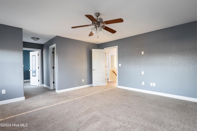 spare room with ceiling fan and carpet