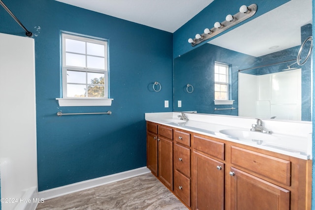 bathroom featuring vanity and a shower