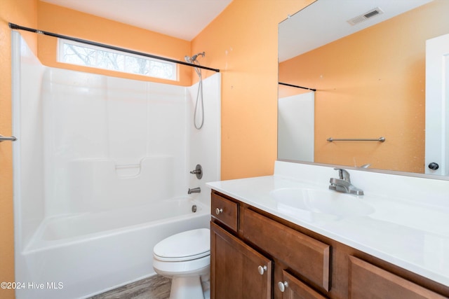 full bathroom with shower / bathtub combination, wood-type flooring, toilet, and vanity