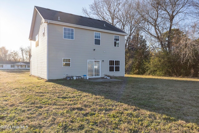 rear view of property with a yard