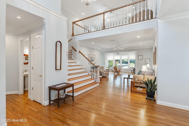 foyer entrance featuring light hardwood / wood-style floors and crown molding