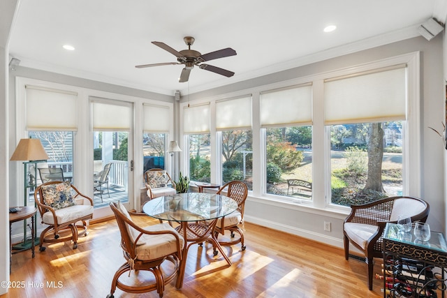 sunroom / solarium featuring ceiling fan