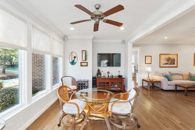 dining space featuring crown molding, ceiling fan, and light hardwood / wood-style floors