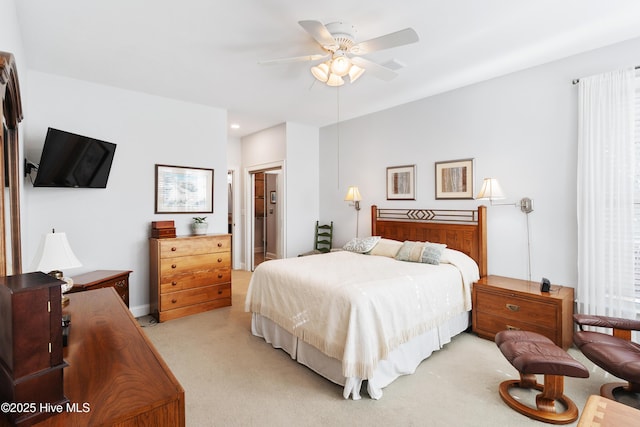 bedroom with ceiling fan and light colored carpet