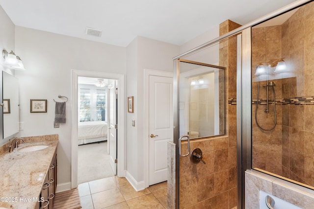 bathroom featuring tile patterned floors, ceiling fan, vanity, and an enclosed shower