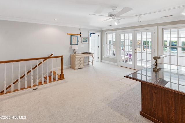 interior space with ceiling fan, french doors, light colored carpet, and ornamental molding