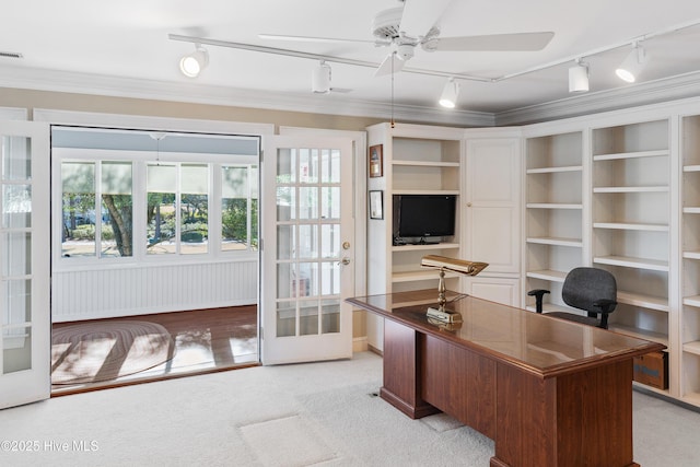 carpeted home office with ceiling fan, crown molding, track lighting, and french doors