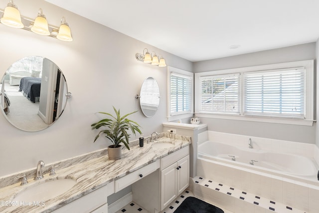 bathroom featuring vanity and tiled bath