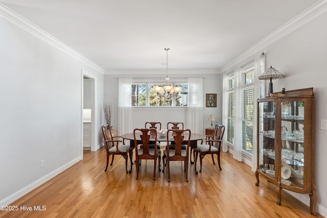 dining space featuring a chandelier, a healthy amount of sunlight, and ornamental molding