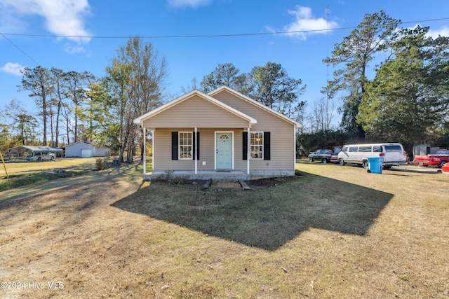 bungalow-style house with a front lawn and covered porch