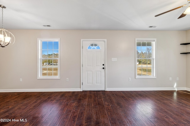 entrance foyer featuring plenty of natural light, dark hardwood / wood-style floors, and ceiling fan with notable chandelier