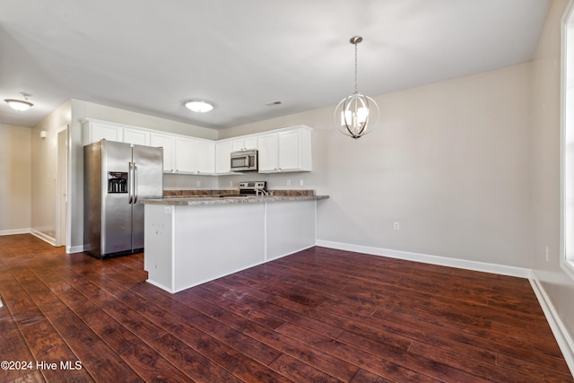 kitchen featuring dark wood-type flooring, stainless steel appliances, kitchen peninsula, decorative light fixtures, and white cabinets