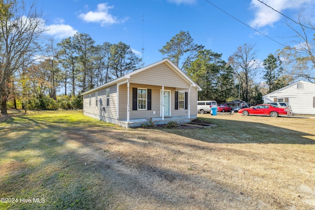 view of front of house with a porch and a front lawn