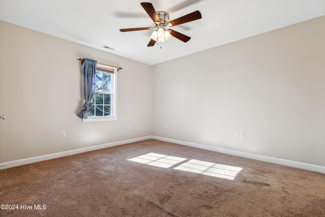 empty room with ceiling fan and carpet floors