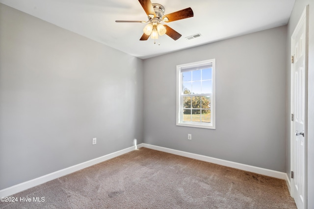 spare room with carpet floors and ceiling fan