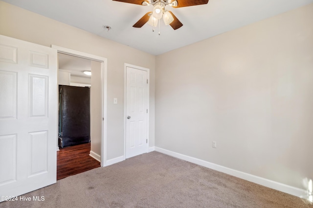 unfurnished bedroom featuring ceiling fan and carpet floors