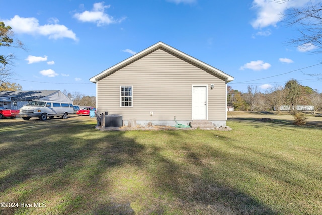 view of home's exterior featuring central AC and a lawn