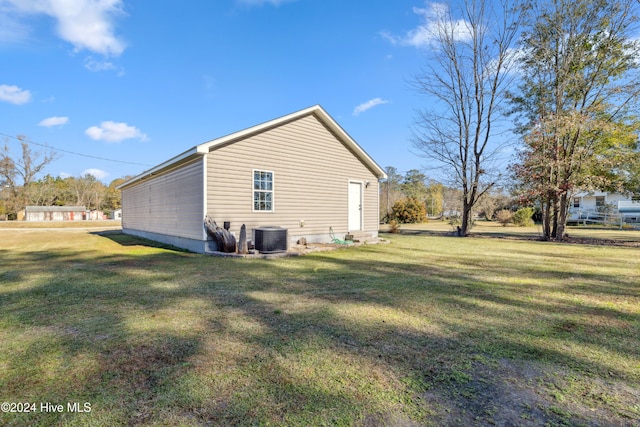 view of property exterior with a yard and central AC