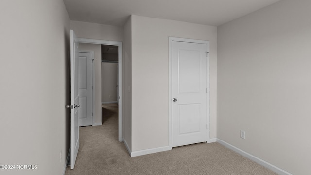 unfurnished bedroom with light carpet