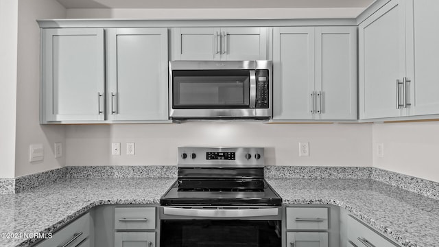 kitchen featuring light stone countertops and appliances with stainless steel finishes