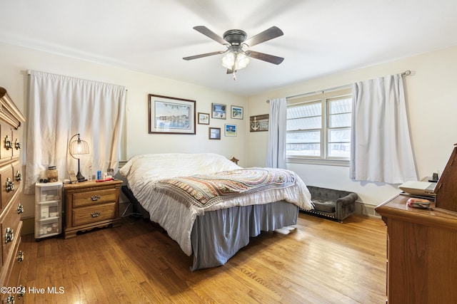 bedroom with light wood-type flooring and ceiling fan