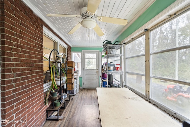 unfurnished sunroom featuring ceiling fan