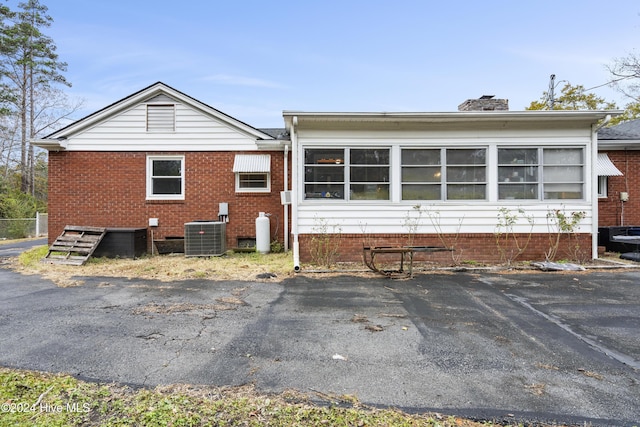 back of property featuring central air condition unit