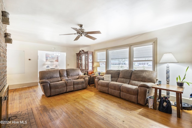 living room with ceiling fan and light hardwood / wood-style flooring