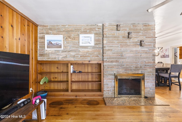 living room with wood-type flooring and a fireplace