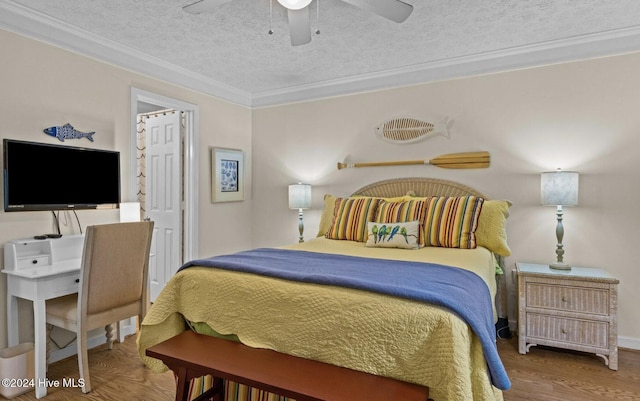 bedroom with a textured ceiling, ceiling fan, crown molding, and hardwood / wood-style floors