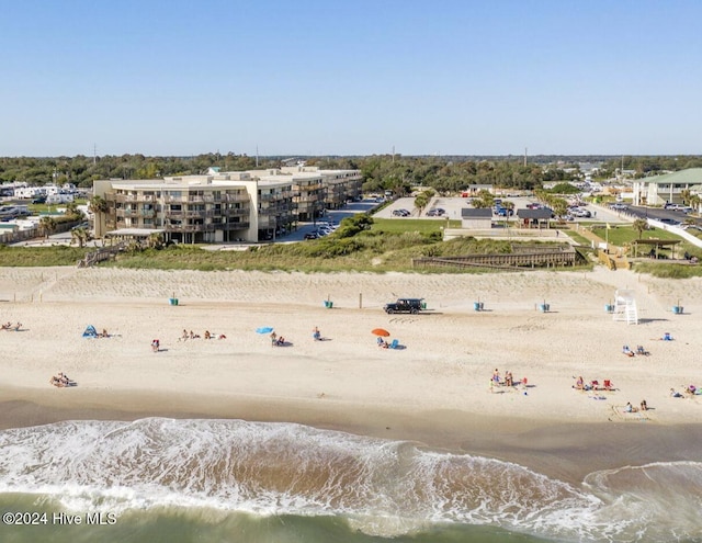 drone / aerial view featuring a water view and a beach view