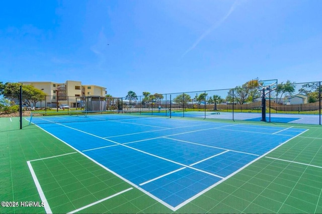 view of tennis court featuring basketball hoop