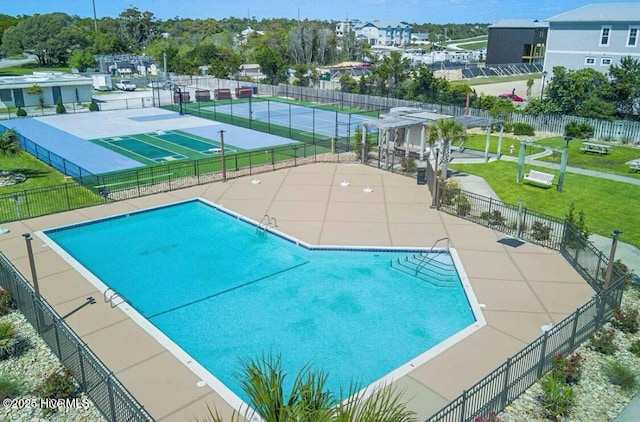 view of swimming pool with a lawn