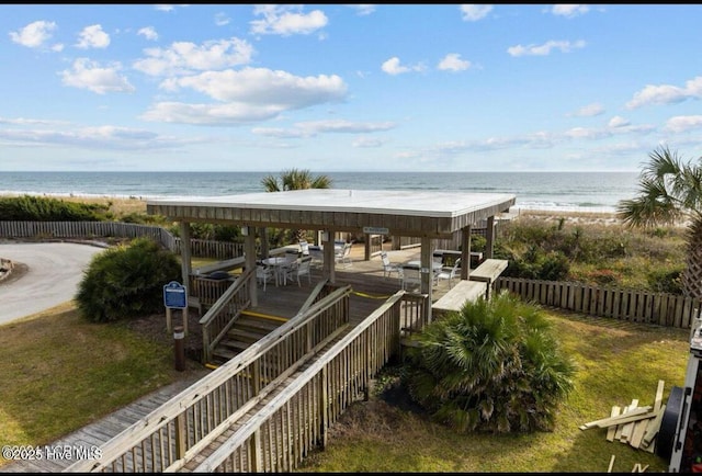 exterior space with a view of the beach and a deck with water view