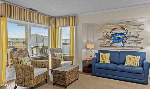 living area featuring a textured ceiling, hardwood / wood-style flooring, and crown molding