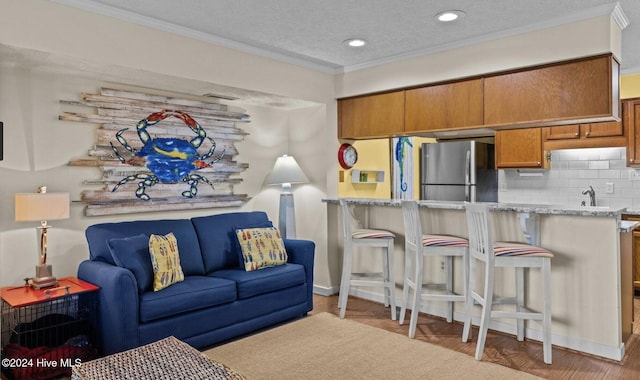 living room featuring a textured ceiling and ornamental molding