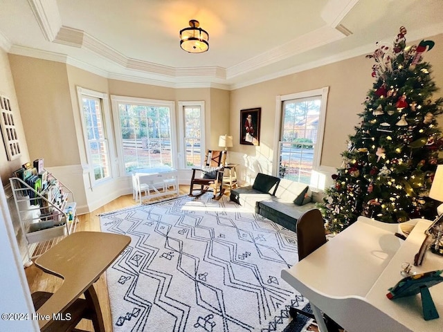 sitting room featuring ornamental molding, hardwood / wood-style flooring, and a healthy amount of sunlight