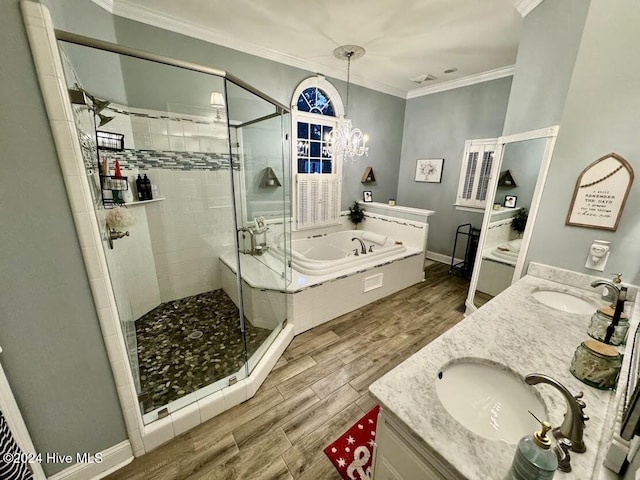 bathroom featuring ornamental molding, vanity, an inviting chandelier, independent shower and bath, and hardwood / wood-style floors