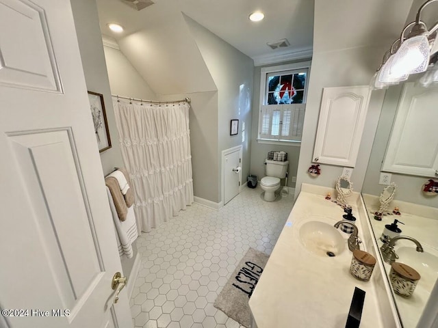 bathroom with tile patterned flooring, vanity, lofted ceiling, and toilet