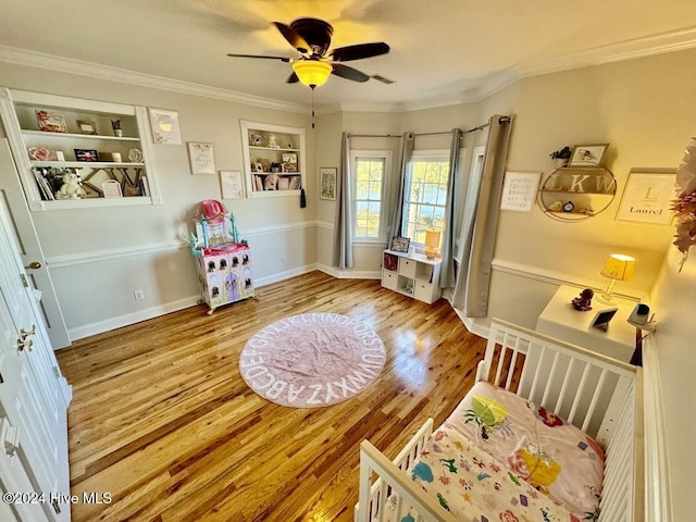 interior space featuring hardwood / wood-style floors, ceiling fan, and ornamental molding