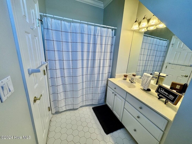 bathroom with tile patterned flooring, vanity, and crown molding