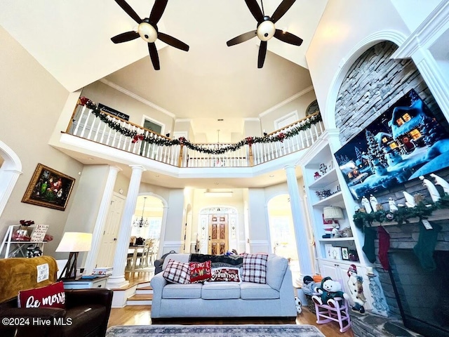 interior space with hardwood / wood-style flooring, crown molding, and a high ceiling