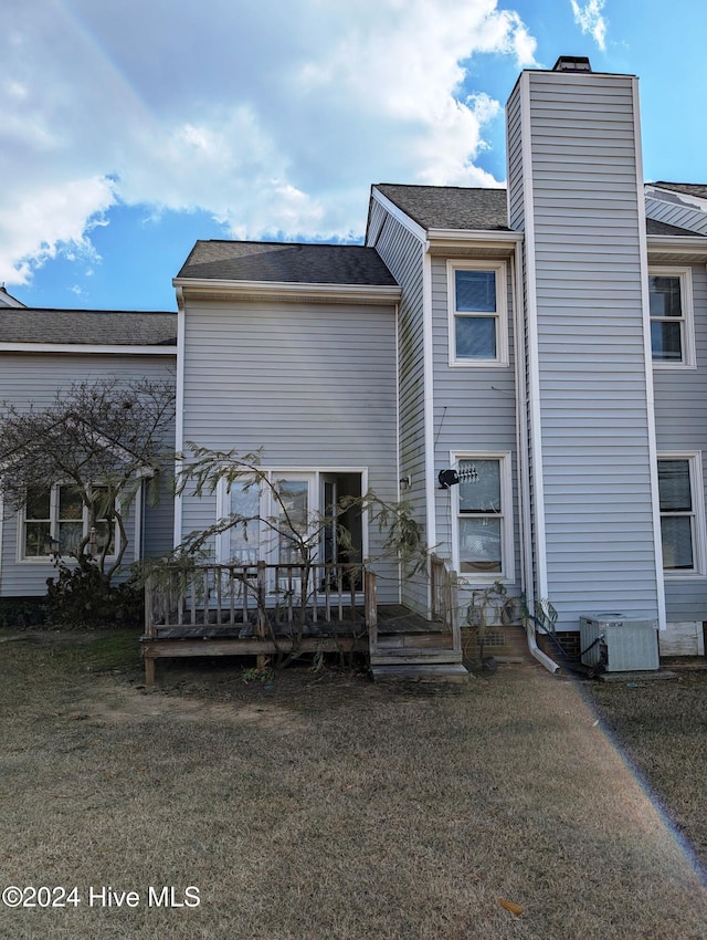 back of property featuring a yard, central AC unit, and a wooden deck