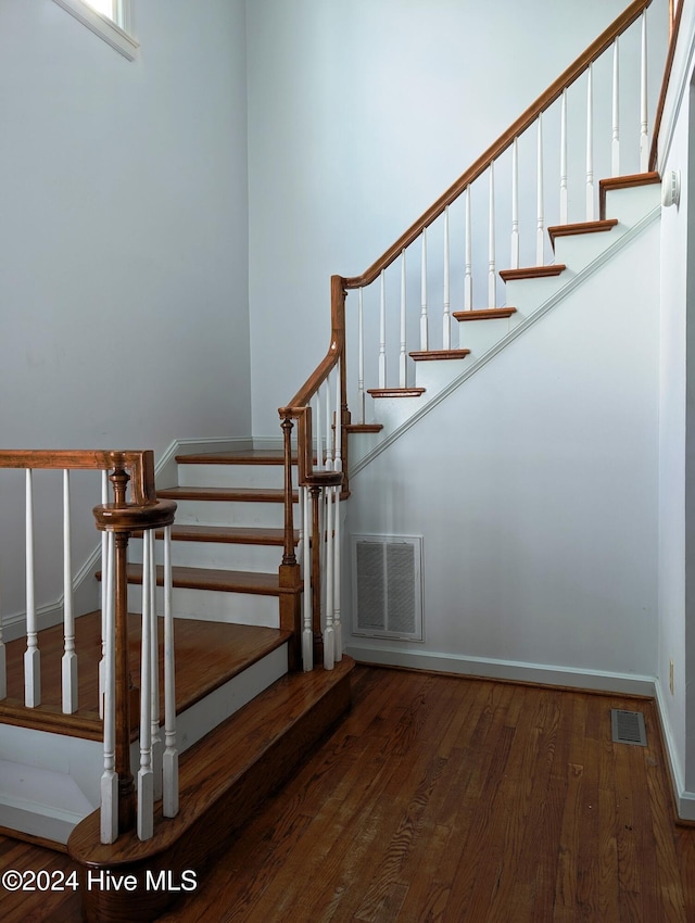 stairs featuring hardwood / wood-style floors