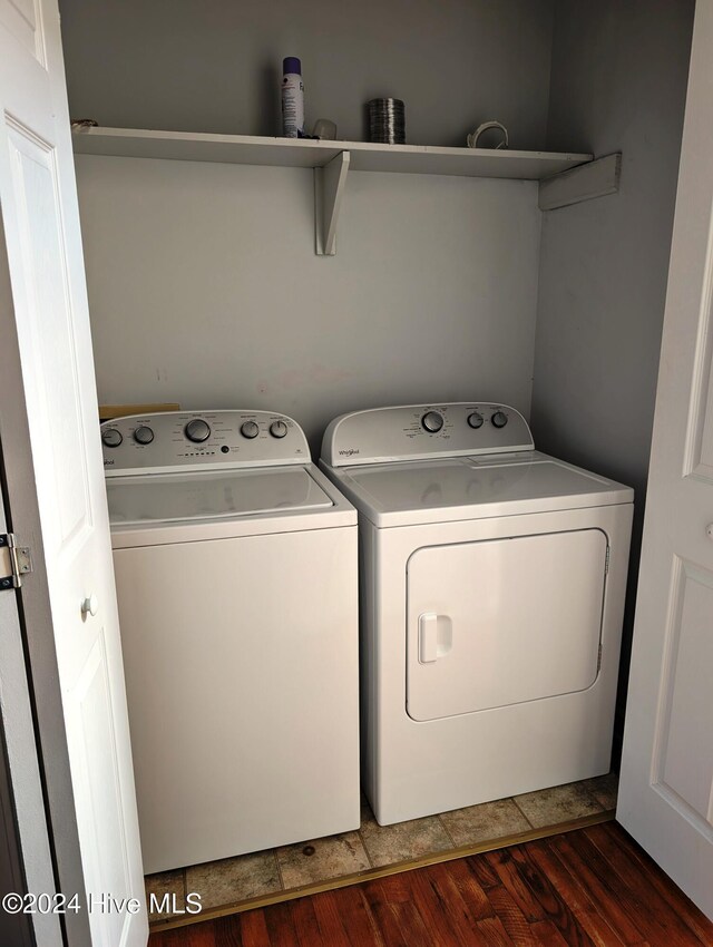 laundry area with washer and clothes dryer and dark hardwood / wood-style floors