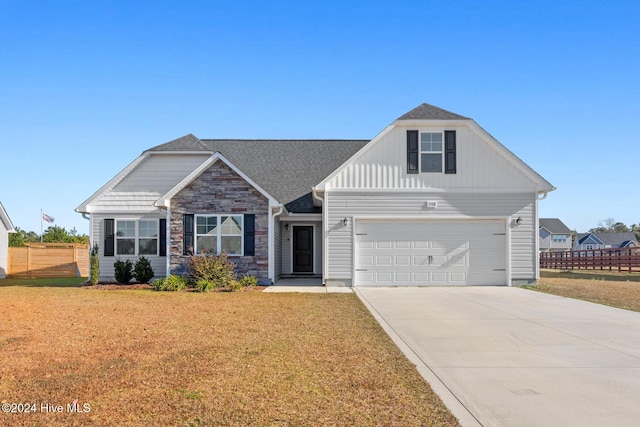 view of front of house with a garage and a front yard