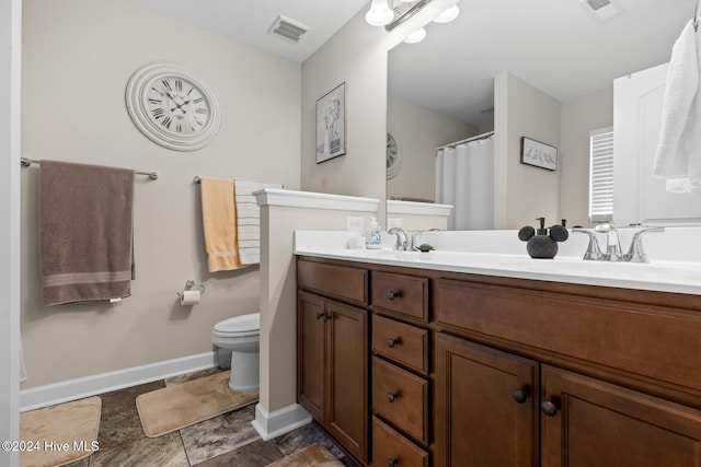 bathroom featuring vanity and toilet