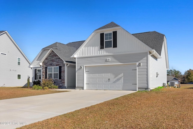 view of front of property with a front yard and a garage