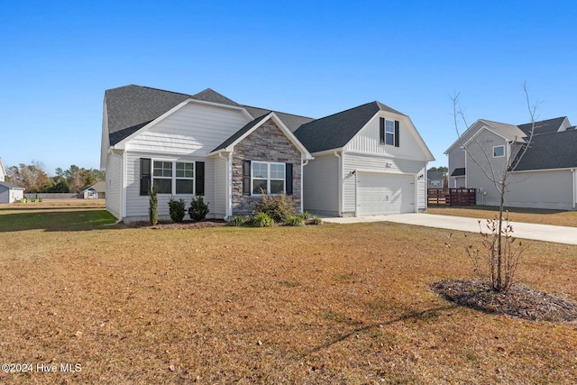 view of front of property with a front lawn and a garage