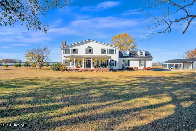 view of front of house with a porch and a front yard